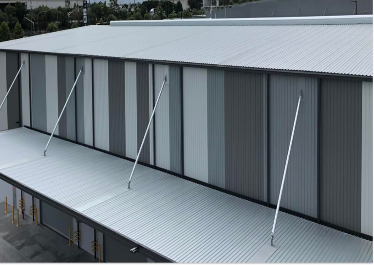 Metal roof installation on an industrial facility in Southeast Queensland, showing corrugated steel panels and large-span roofing by Envy Roofing.
