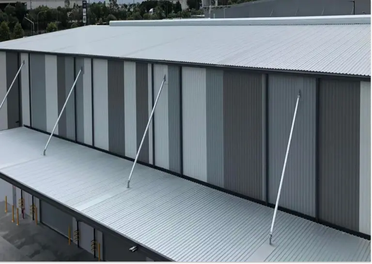 Metal roof installation on an industrial facility in Southeast Queensland, showing corrugated steel panels and large-span roofing by Envy Roofing.