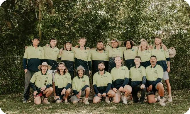 Team photo of Envy Roofing staff standing together outdoors, representing the family-owned company featured in the About Us Envy Roofing page.