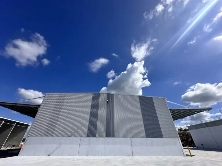 Completed cladding installation on a modern industrial facility under blue skies in Queensland.