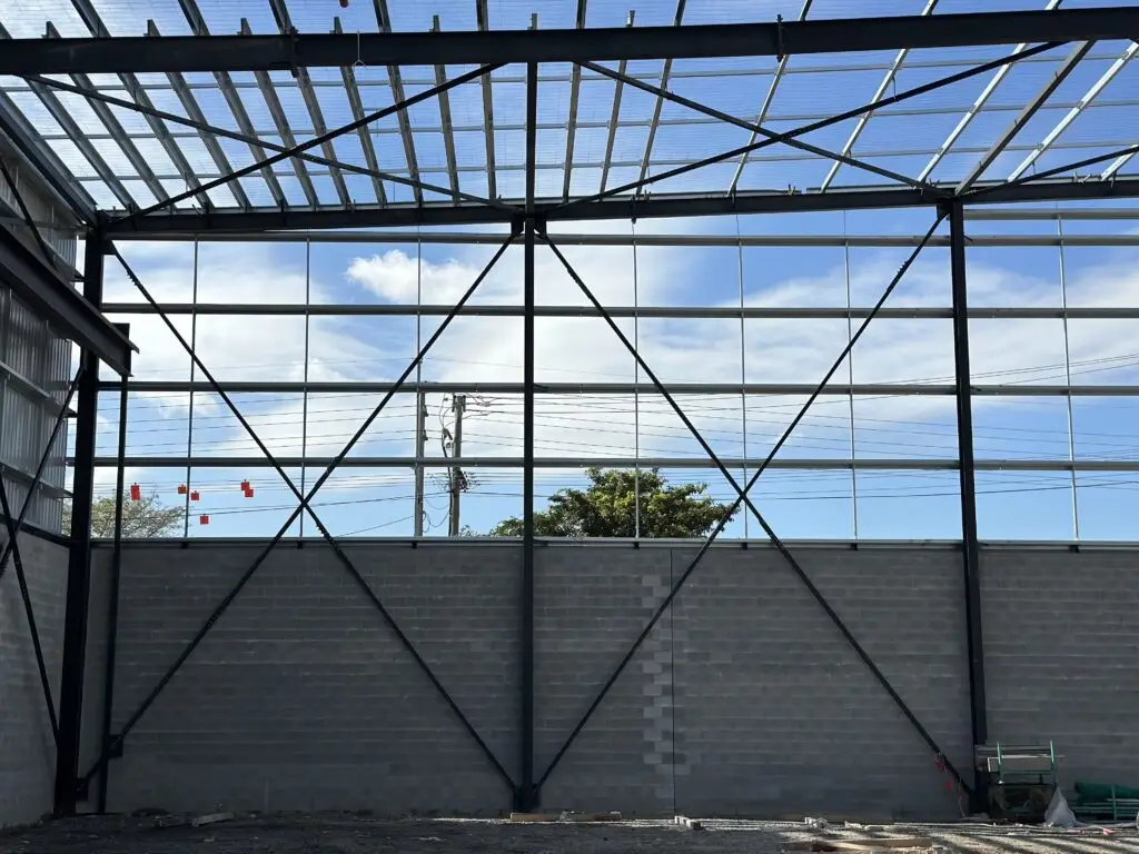 Roof Replacement Brisbane project underway on a steel-framed commercial building, ensuring structural integrity and local compliance.
