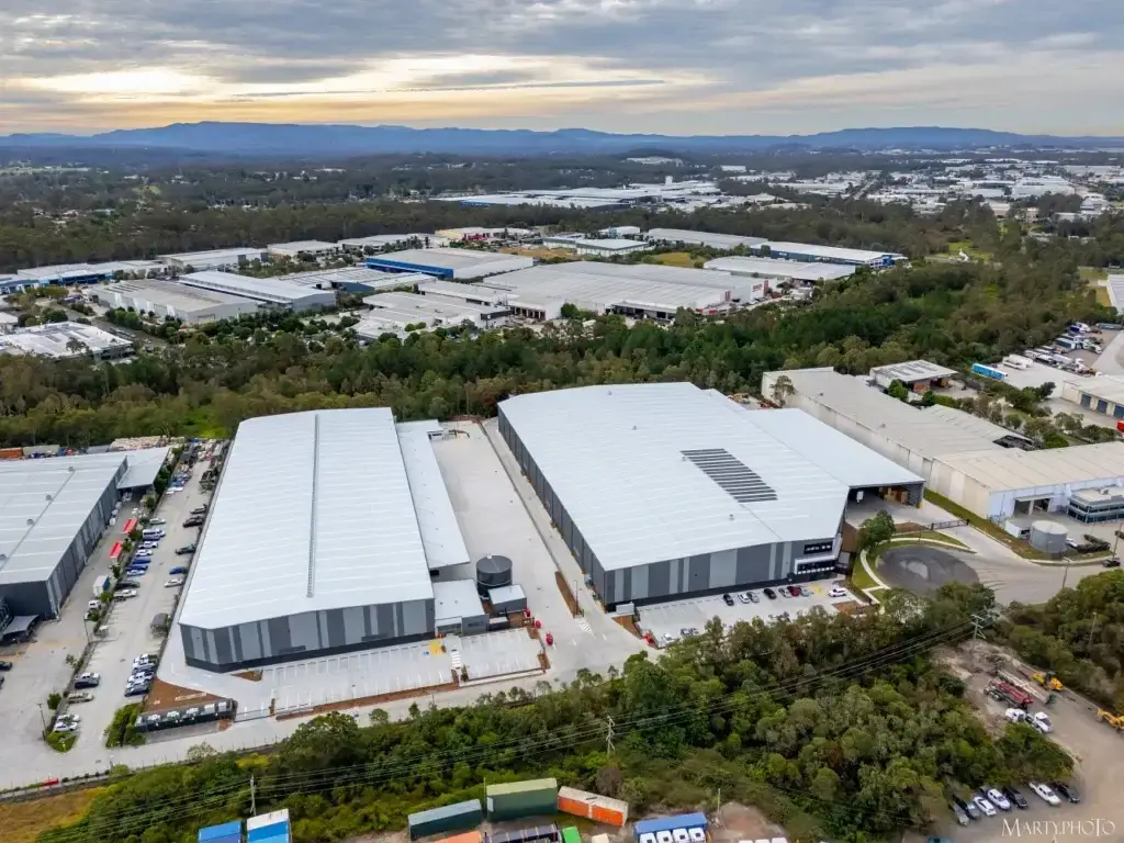 Aerial view of completed industrial warehouses in Carole Park with large-scale metal roofing installed by Envy Roofing