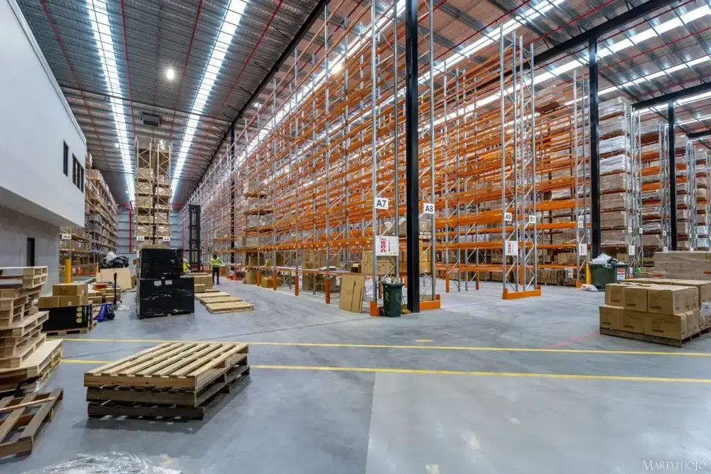 Industrial storage facility in Carole Park showcasing Envy Roofing’s large-scale roofing work and integrated lighting